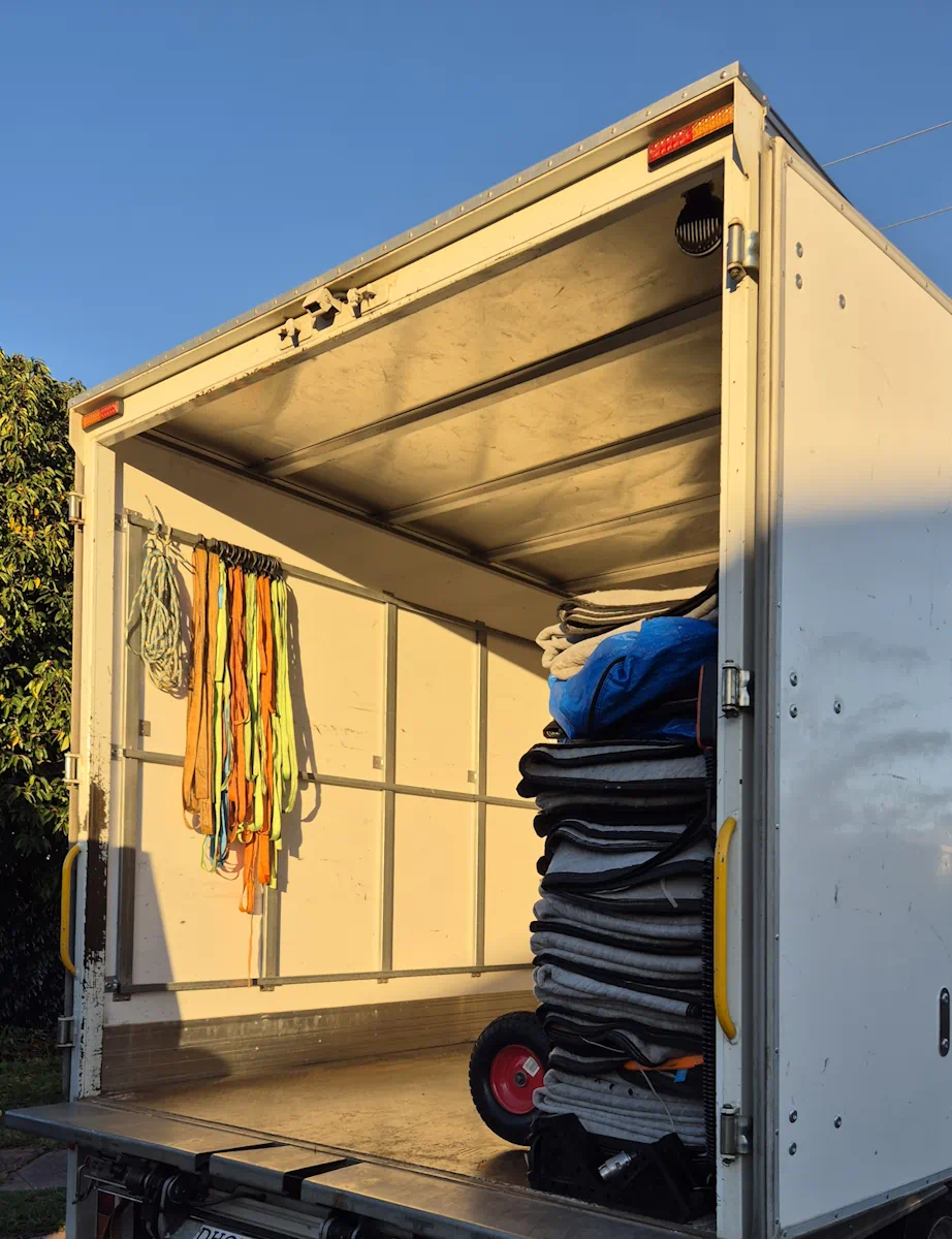 Open moving truck with blankets and straps
