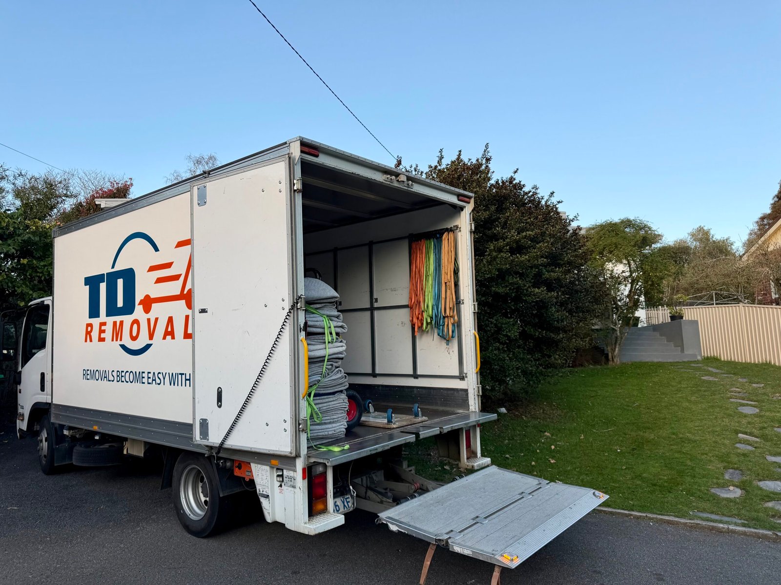 Removal truck with open storage compartments and moving blankets